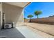 Covered patio with storage and clear view of the spacious gravel and dirt backyard at 30100 N Sunray Dr, San Tan Valley, AZ 85143
