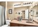 This bathroom features a single sink, a framed mirror and a shower with a curtain at 30285 W Leah Dr, Buckeye, AZ 85396