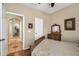 Bedroom view showing an archway leading to the hallway and a white door beside a wood dresser at 30285 W Leah Dr, Buckeye, AZ 85396