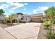 Attractive home with desert landscaping, and a long driveway leading to the attached two-car garage at 30285 W Leah Dr, Buckeye, AZ 85396