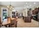 Open-concept kitchen flows into the living space, featuring dark wood cabinets and granite countertops at 30285 W Leah Dr, Buckeye, AZ 85396