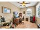 Comfortable office space with lots of natural light, a ceiling fan, and a vintage barber chair at 30285 W Leah Dr, Buckeye, AZ 85396