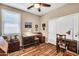An office space with a workbench, a desk with a chair and a vintage storage chest at 30285 W Leah Dr, Buckeye, AZ 85396