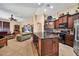 Spacious open-concept living area featuring a kitchen with granite countertops and bar stool seating at 30285 W Leah Dr, Buckeye, AZ 85396