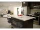 Modern kitchen features a large island with seating, stainless steel appliances, and sleek countertops at 3208 W Bloomfield Rd, Phoenix, AZ 85029
