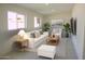 Inviting living room with neutral tones, plush seating, and large windows for abundant natural light at 3208 W Bloomfield Rd, Phoenix, AZ 85029