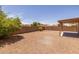 Open backyard featuring low-maintenance desert landscaping, a privacy fence, and a covered patio at 3843 E Citrine Rd, San Tan Valley, AZ 85143