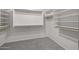 Walk-in closet with built in shelves and rods at 3843 E Citrine Rd, San Tan Valley, AZ 85143