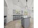This stunning kitchen features stainless steel appliances, gray cabinets, granite countertops, an island, and modern lighting at 3843 E Citrine Rd, San Tan Valley, AZ 85143