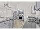 Modern kitchen with an island, stainless steel appliances, gray cabinets, granite countertops, and modern lighting fixtures at 3843 E Citrine Rd, San Tan Valley, AZ 85143