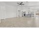 Open-concept living space boasts neutral paint, tile floors, contemporary lighting, and seamless flow into the kitchen at 3843 E Citrine Rd, San Tan Valley, AZ 85143