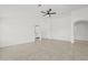 Spacious living area boasts arched doorways, recessed lighting, a ceiling fan, and neutral paint and flooring at 3843 E Citrine Rd, San Tan Valley, AZ 85143