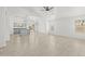 Bright and airy living space features neutral paint, tile floors, contemporary lighting, and seamless flow into the kitchen at 3843 E Citrine Rd, San Tan Valley, AZ 85143