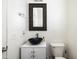 Modern half bathroom featuring a vessel sink, decorative mirror, and stylish fixtures at 3952 E Frances Ln, Gilbert, AZ 85295