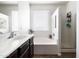 Bright bathroom featuring a separate shower and soaking tub with a large window at 3952 E Frances Ln, Gilbert, AZ 85295