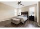 Bright bedroom with hardwood floors, a ceiling fan, and ample natural light from two windows at 3952 E Frances Ln, Gilbert, AZ 85295