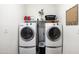 Functional laundry room with washer, dryer, shelving, and stylish organizational touches at 3952 E Frances Ln, Gilbert, AZ 85295