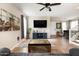 Spacious living room featuring a mounted TV, tile flooring, and an open layout perfect for entertaining at 3952 E Frances Ln, Gilbert, AZ 85295