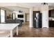 Spacious living room boasts neutral walls, updated tile flooring, and a large black refrigerator at 3952 E Frances Ln, Gilbert, AZ 85295