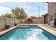 Backyard pool with patio furniture and BBQ, surrounded by block wall for privacy and landscaping at 3952 E Frances Ln, Gilbert, AZ 85295