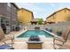Backyard view showcasing a pool, outdoor seating, fire pit, and surrounding houses at 3952 E Frances Ln, Gilbert, AZ 85295