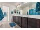 The primary bathroom showcases a double vanity, ample mirror, and a shower-tub combination at 4044 S 58Th Ln, Phoenix, AZ 85043