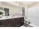 Bathroom with double sink vanity and framed mirror, with a tub-shower combination and privacy curtain at 4044 S 58Th Ln, Phoenix, AZ 85043