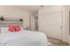 Bedroom with wood accent wall, bedside tables and lamps, and plush white bedding with coral pillows at 4044 S 58Th Ln, Phoenix, AZ 85043