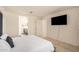 A view from the primary bedroom of a bathroom and tv on wall at 4044 S 58Th Ln, Phoenix, AZ 85043