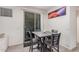Cozy dining area with a gray table and four chairs, adjacent to a sliding glass door at 4044 S 58Th Ln, Phoenix, AZ 85043