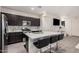 Open-concept kitchen with a large island, dark cabinets, and modern appliances, flowing into the living area at 4044 S 58Th Ln, Phoenix, AZ 85043