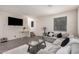 Bright living room featuring a plush sectional sofa and a modern glass coffee table at 4044 S 58Th Ln, Phoenix, AZ 85043