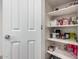 Pantry with white shelves stocked with an assortment of food items and household essentials at 4044 S 58Th Ln, Phoenix, AZ 85043