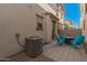 Outdoor patio area with blue chairs, table and air conditioner near a block wall at 4044 S 58Th Ln, Phoenix, AZ 85043