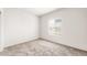 Neutral bedroom with fresh white walls, carpeted floors, and a window view at 42920 W Palo Amarillo Rd, Maricopa, AZ 85138