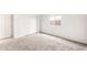 Neutral bedroom with fresh white walls, carpeted floors, and a window view at 42920 W Palo Amarillo Rd, Maricopa, AZ 85138