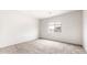 Neutral bedroom with fresh white walls, carpeted floors, and a window view at 42920 W Palo Amarillo Rd, Maricopa, AZ 85138