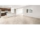 Bright open-concept living space with kitchen, stainless appliances, and tiled floors at 42920 W Palo Amarillo Rd, Maricopa, AZ 85138