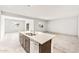 Open concept kitchen features granite island and stainless steel appliances in a bright interior at 42920 W Palo Amarillo Rd, Maricopa, AZ 85138