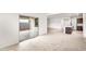 Bright living area with tile floors, sliding glass doors to the outside and view into kitchen at 42920 W Palo Amarillo Rd, Maricopa, AZ 85138