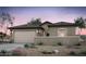 Charming single-story home boasts desert landscaping, a two-car garage, and a neutral color palette at 42960 W Palo Amarillo Rd, Maricopa, AZ 85138