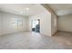 Open living room with tile flooring, bright natural light, and sliding door to backyard at 42960 W Palo Amarillo Rd, Maricopa, AZ 85138