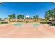 Community basketball court featuring a full court with hoops, seating, and a landscaped perimeter at 44158 W Canyon Creek Dr, Maricopa, AZ 85139