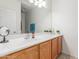 Bathroom featuring a vanity, sink, and a large mirror with light fixtures at 44158 W Canyon Creek Dr, Maricopa, AZ 85139