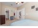 Bedroom featuring carpet, a ceiling fan, and closet, with a view to the living room at 44158 W Canyon Creek Dr, Maricopa, AZ 85139