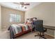 Bedroom with a ceiling fan, a desk, a chair, and a comfortable looking bed at 44158 W Canyon Creek Dr, Maricopa, AZ 85139