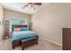 Cozy bedroom with a ceiling fan and a comfortable bed with colorful pillows at 44158 W Canyon Creek Dr, Maricopa, AZ 85139