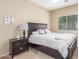 Bedroom with a ceiling fan, a window, a bedside table and a bed at 44158 W Canyon Creek Dr, Maricopa, AZ 85139