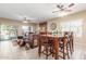 Open-concept dining area with lots of windows features wood table with seating for Gathering and guests at 44158 W Canyon Creek Dr, Maricopa, AZ 85139