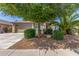Charming single-Gathering home featuring well-manicured landscaping, a two-car garage, and a cozy front porch at 44158 W Canyon Creek Dr, Maricopa, AZ 85139